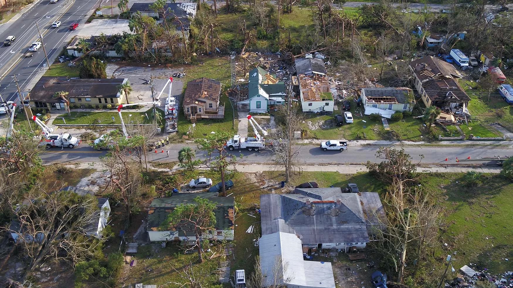 Linework trucks at storm disaster site.